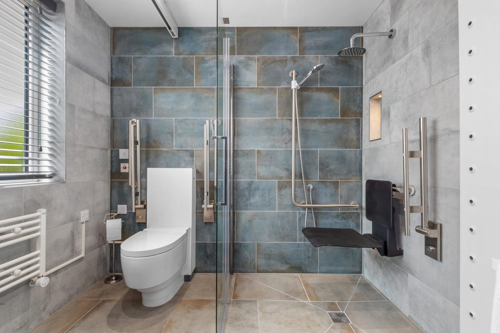 Accessible wetroom with shower screen folded out and optional shower seat