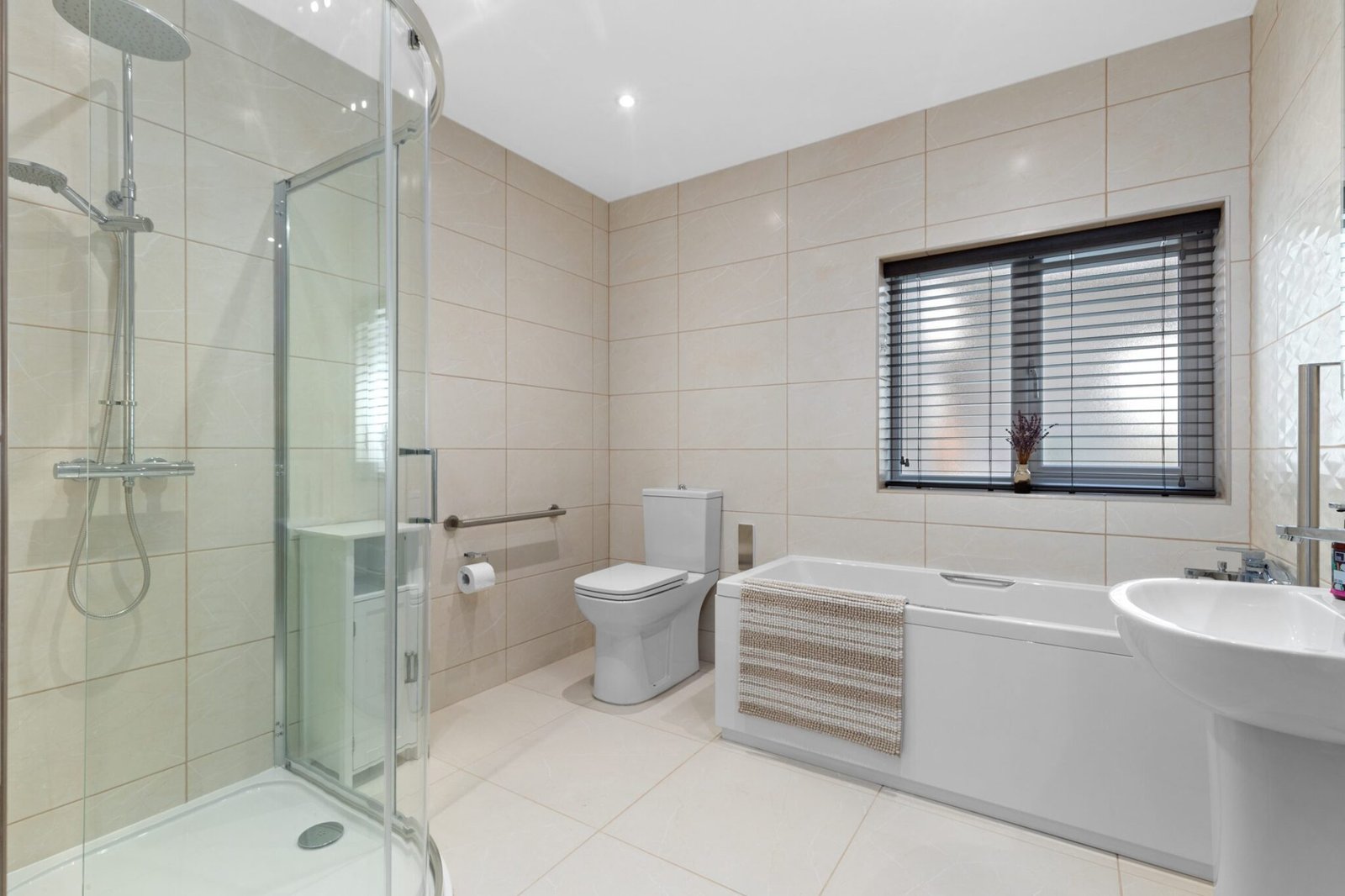 Bathroom with peninsula high seat toilet and walk in shower