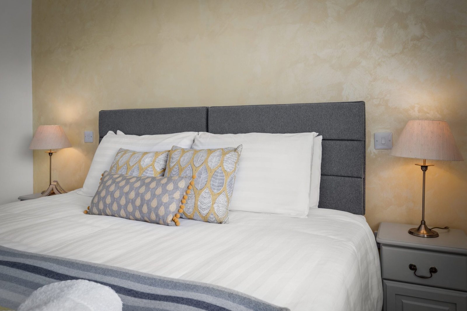 Crisp white bedding and Welsh fabrics cushions to lull you to sleep