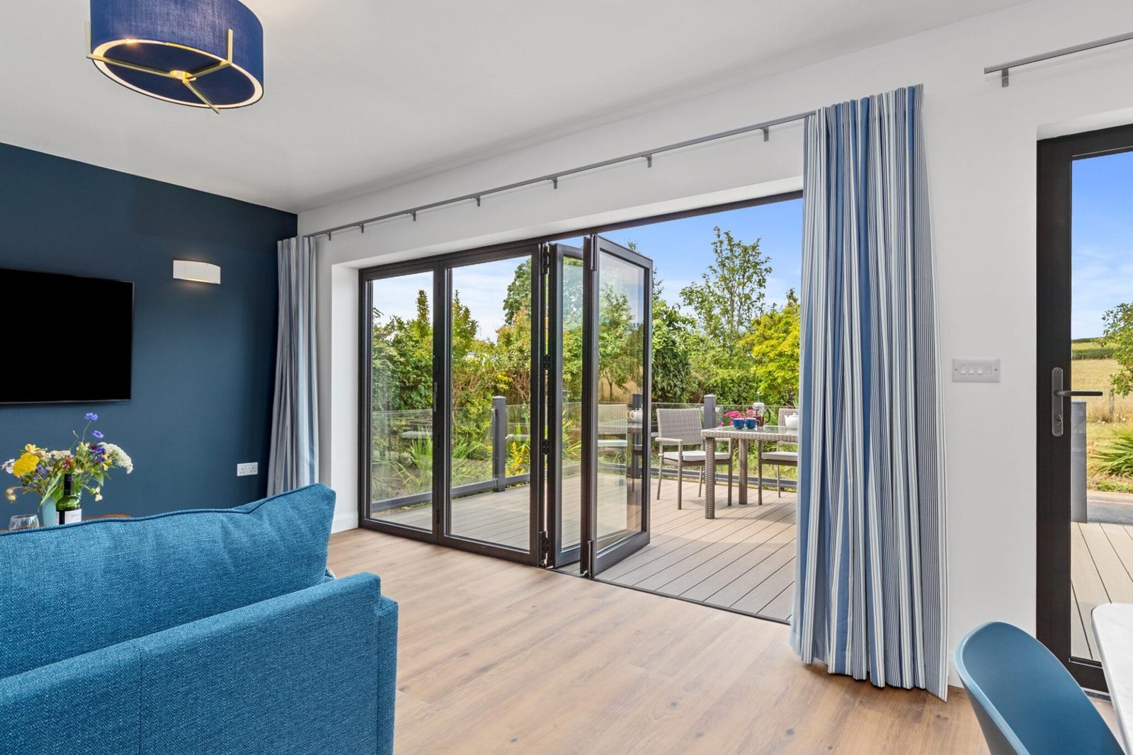 Folding-sliding doors with level access between lounge and deck